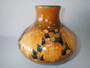 1928 William Moorcroft signed salt glaze Leaf and Berries vase in autumnal ochre, amber and brown tones.