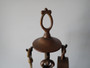 Victorian brass fireplace companion set with poker, tongs, shovel and brush on decorative stand circa 1880–1910.