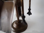 Victorian brass fireplace companion set with poker, tongs, shovel and brush on decorative stand circa 1880–1910.