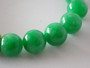Vintage Chinese green jade bead stretch bracelet with natural internal clouding and 9ct gold gem-set spacer.
