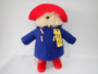 Large Rainbow Designs collector Paddington Bear wearing a blue duffle coat, red hat, red Wellington boots and original luggage label.