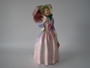 Doulton Miss Demure 1930s bone china lady figurine in a pink gown with green bonnet and parasol, measuring 20cm tall.