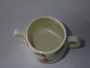 Vintage Royal Doulton Bunnykins two-handled ceramic mug featuring rabbits knitting with colourful wool and hopping rabbits around the rim.