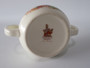 Vintage Royal Doulton Bunnykins two-handled ceramic mug featuring rabbits knitting with colourful wool and hopping rabbits around the rim.