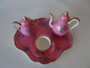Mid 19th century child’s tea set with pink floral decoration including tray teapot creamer and cup