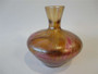 Antique pink and golden yellow iridescent art glass vase with rounded baluster body and flared neck, 13.5cm tall.