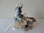 Bing & Grøndahl Fisherman's Wife Danish porcelain figurine in traditional dress seated beside baskets, circa 1950s, 20cm tall.