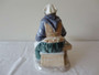 Bing & Grøndahl Fisherman's Wife Danish porcelain figurine in traditional dress seated beside baskets, circa 1950s, 20cm tall.