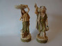 Pair of antique Royal Dux water carrier figurines depicting a man and woman in traditional Middle Eastern attire, circa 1910.