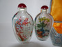 Pair of Chinese glass snuff bottles of ovoid form and decorated with blossoming branches and bamboo with inscriptions, has stoppers and original box.