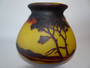 Antique Muller Frères Lunéville cameo glass vase with amber-yellow background, brown acid-etched trees, woodland landscape and flared neck.