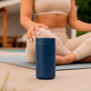 Matte navy Simple insulated coffee tumbler with matching lid beside a yoga mat and a person seated cross-legged outdoors.