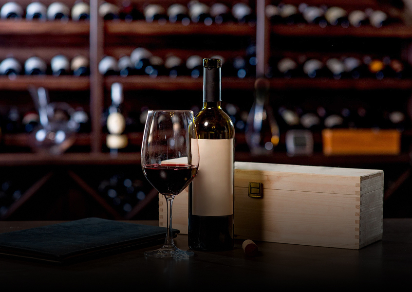 A wine bottle and a glass with red wine