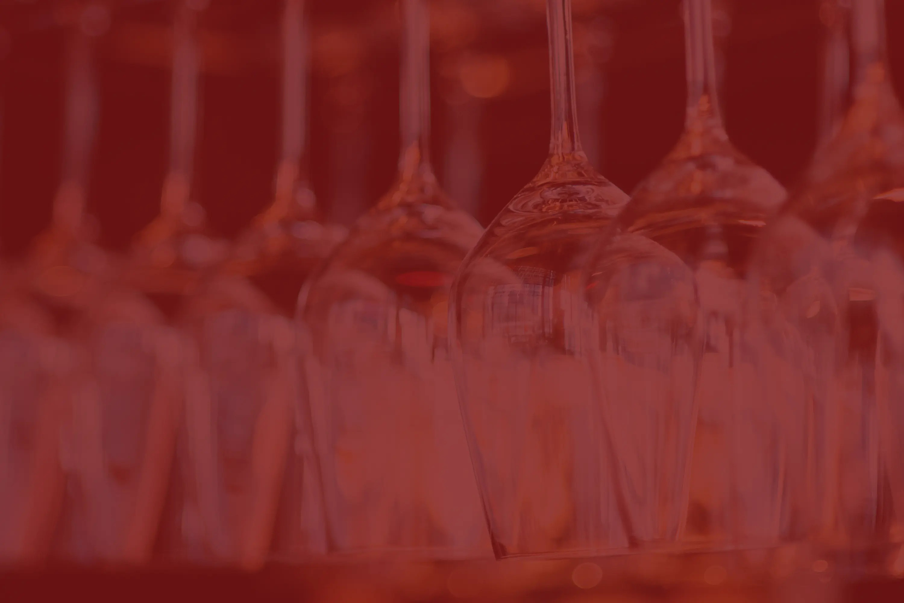 a close up of wine glasses hanging upside down