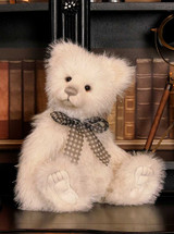 A white fluffy Charlie Bears teddy bear sits upright, wearing a grey gingham bow tie. It has silver-tipped fur, a grey velvet nose, and detailed paw pads.