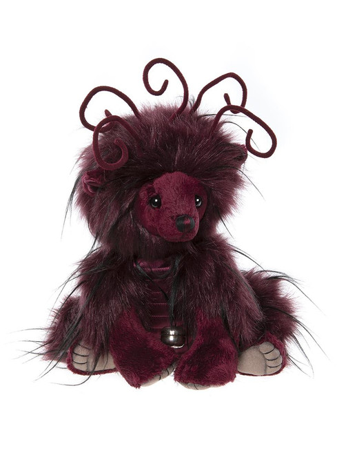 A dark burgundy Charlie Bear teddy sits upright, featuring wild fluffy fur, long black streaks, curly velvet antennae, and a small silver ball pendant necklace, against a white background.