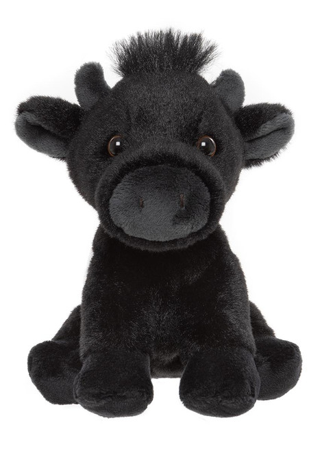A black plush cow teddy bear with small horns, a grey muzzle, brown eyes, a white patch on its chest, and a tuft of hair on its head, sitting upright against a white background.