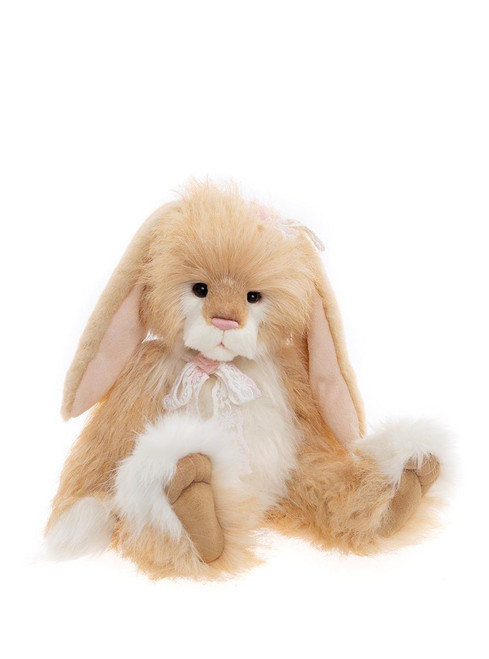 A fluffy golden/cream plush bunny rabbit sits upright against a white background, featuring long floppy ears, a white chest, pink nose, and delicate lace ribbon decoration.