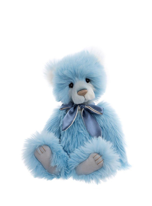 A blue plush teddy bear sits upright against a white background, featuring white inner ears and muzzle, grey paw pads, and a satin blue bow tie at its neck.