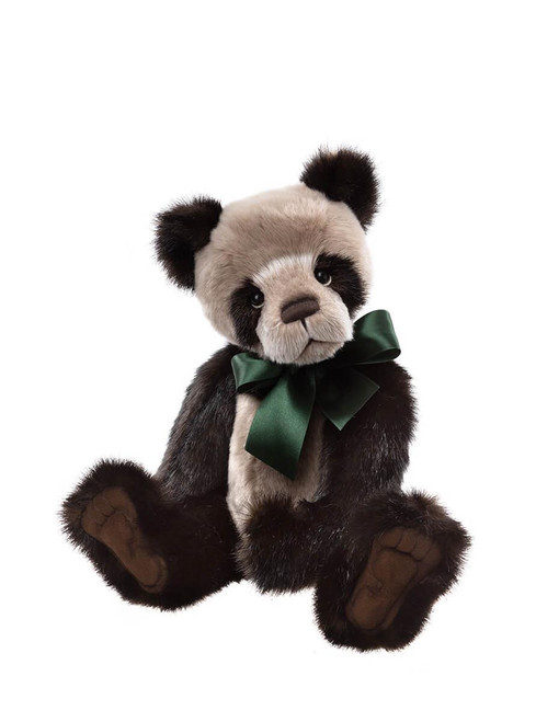 A panda-style Charlie Bears teddy bear sits upright against a white background, featuring dark brown and cream plush fur, with a green satin bow tied at the neck.