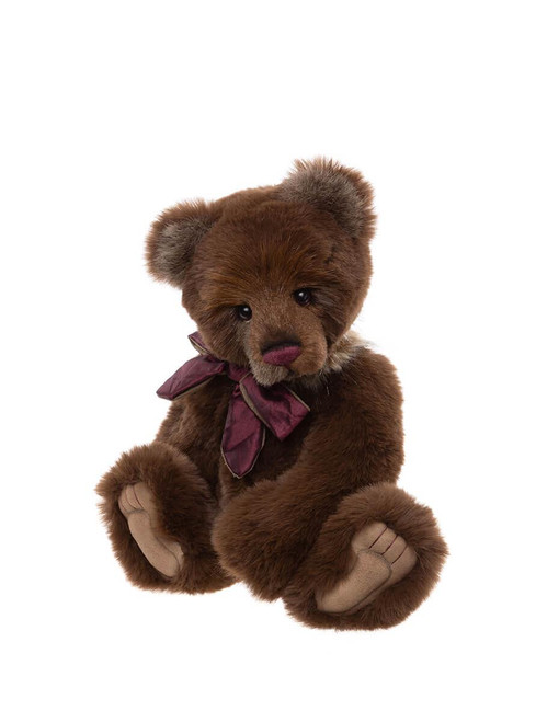 A dark brown Charlie Bears teddy bear sits upright against a white background, wearing a burgundy velvet bow tie around its neck.