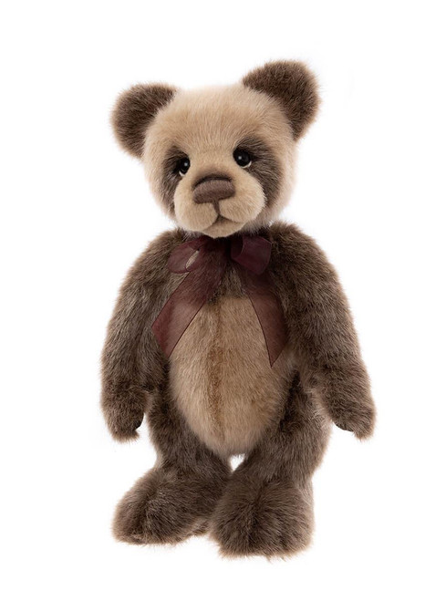 A brown and beige plush panda-style teddy bear stands upright, wearing a dark burgundy ribbon bow at its neck, against a white background.