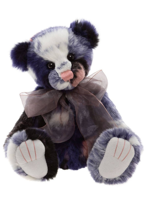 A blue, white, and dark purple patchwork Charlie Bear teddy bear sits upright, wearing a sheer grey organza bow, with white felt paw pads, against a white background.