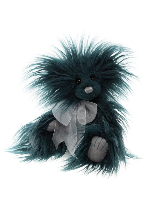 A teal/dark green long-haired Charlie Bear teddy sits upright against a white background, wearing a silver organza bow ribbon around its neck, with grey paw pads visible.
