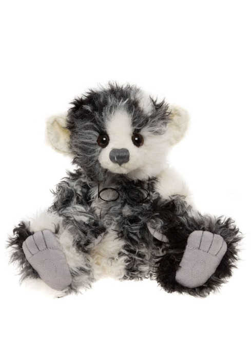 A black, grey, and white fluffy Charlie Bears teddy bear sits upright against a white background, featuring large round ears, brown eyes, a grey nose, and grey suede paw pads.