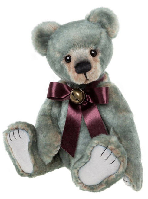 A grey-green plush teddy bear sits upright against a white background, wearing a dark burgundy satin bow tie adorned with a small gold jingle bell.