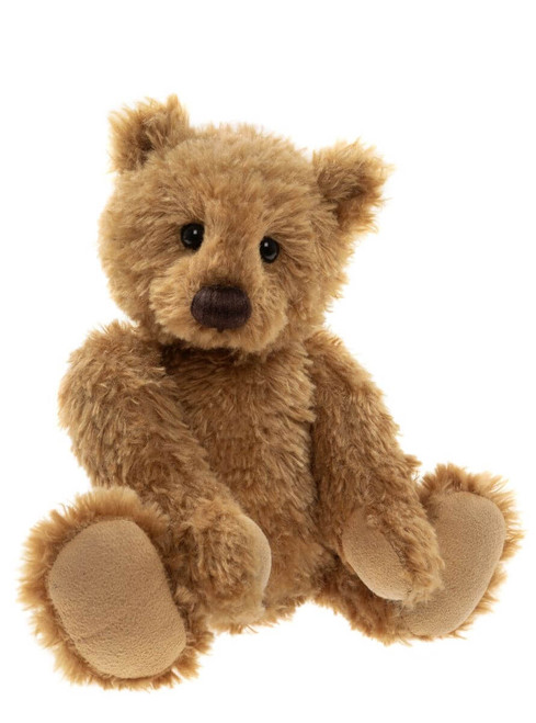 A golden-brown Charlie Bears teddy bear sits upright against a white background, featuring shaggy fur, small dark eyes, a dark nose, and suede-like paw pads.