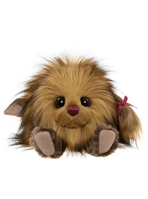 A fluffy brown teddy bear sits facing forward, with large glossy eyes, a dark pink nose, small paws, and a burgundy ribbon bow on its side tail.