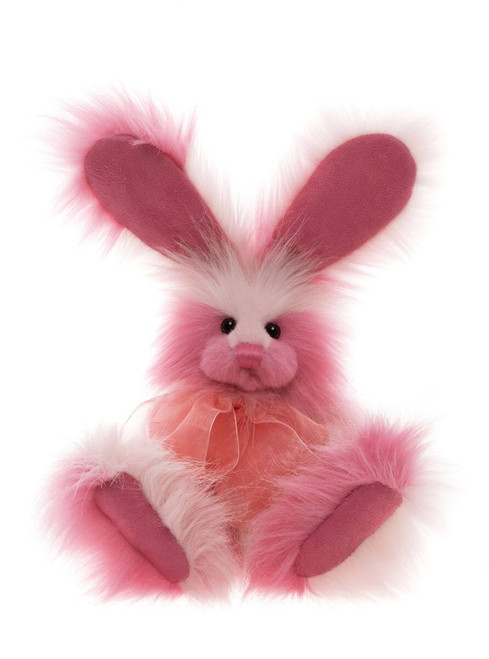 A pink fluffy Charlie Bears bunny rabbit plush toy sits upright against a white background, featuring long ears, white facial fur, and a peach organza bow at the neck.