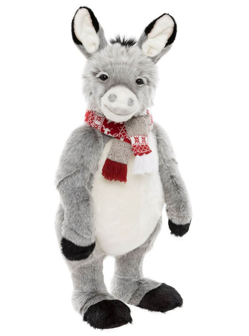 A grey plush donkey teddy bear stands upright wearing a red and white Nordic-patterned scarf with fringe tassels, photographed against a white background.