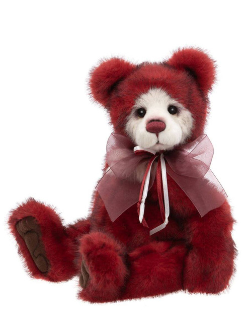 A deep red, panda-style Charlie Bear sits upright against a white background, featuring a white facial mask, dark eyes, and a sheer pink ribbon bow at its neck.