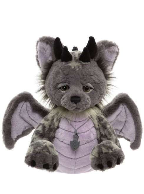 A grey and lavender plush fantasy cat-dragon hybrid Charlie Bear sits upright, featuring bat wings, black horns, whiskers, and a small fish-shaped pendant necklace, against a white background.