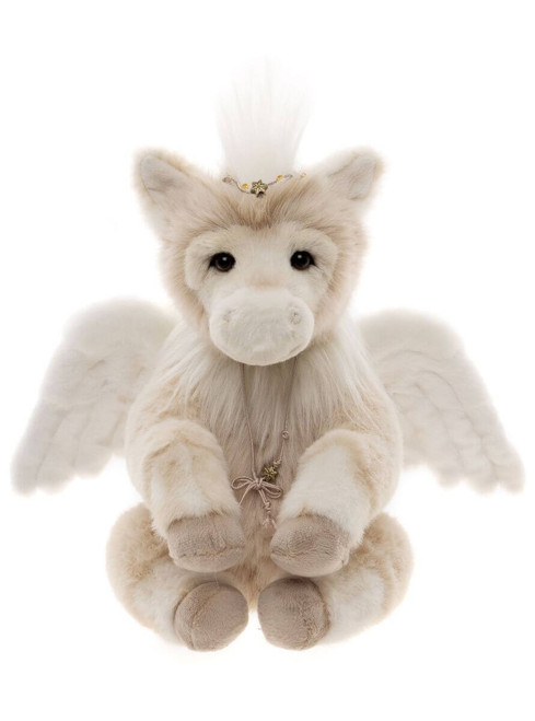 A cream/beige plush Pegasus bear sits upright against a white background, featuring white feathered wings, a feathered mane, a decorative tiara, and a delicate key necklace.