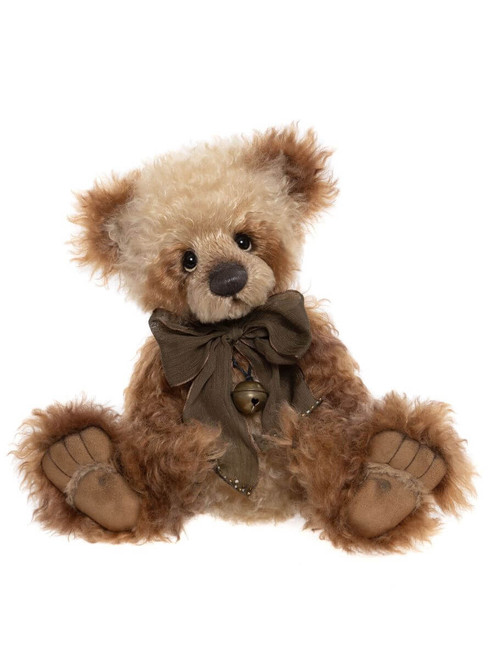 A curly, golden-brown Charlie Bears teddy bear sits upright against a white background, wearing an olive-green bow tied at the neck with a small brass jingle bell.