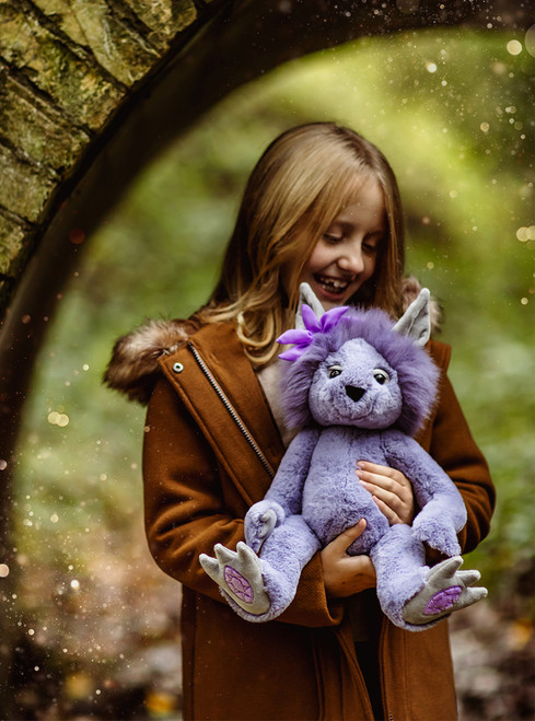 A grey and purple plush wolf/fox-style Charlie Bear sits upright, featuring pointed ears, purple spiky hair, large clawed feet with purple oval paw pads, and expressive eyes.