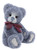 A grey-blue plush teddy bear sits upright, wearing a dark red bow tie, with lighter fur on its muzzle and pale suede paw pads, set against a white background.