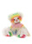 A rainbow tie-dye patterned Charlie Bear teddy sits upright, featuring multicoloured fur in pink, yellow, green, orange, and blue, with a pink bow and small silver bell around its neck.