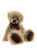 A fluffy, long-haired teddy bear with cream and brown tipped fur sits upright against a white background, wearing a dark brown ribbon bow at its neck, with dark suede oval paw pads.