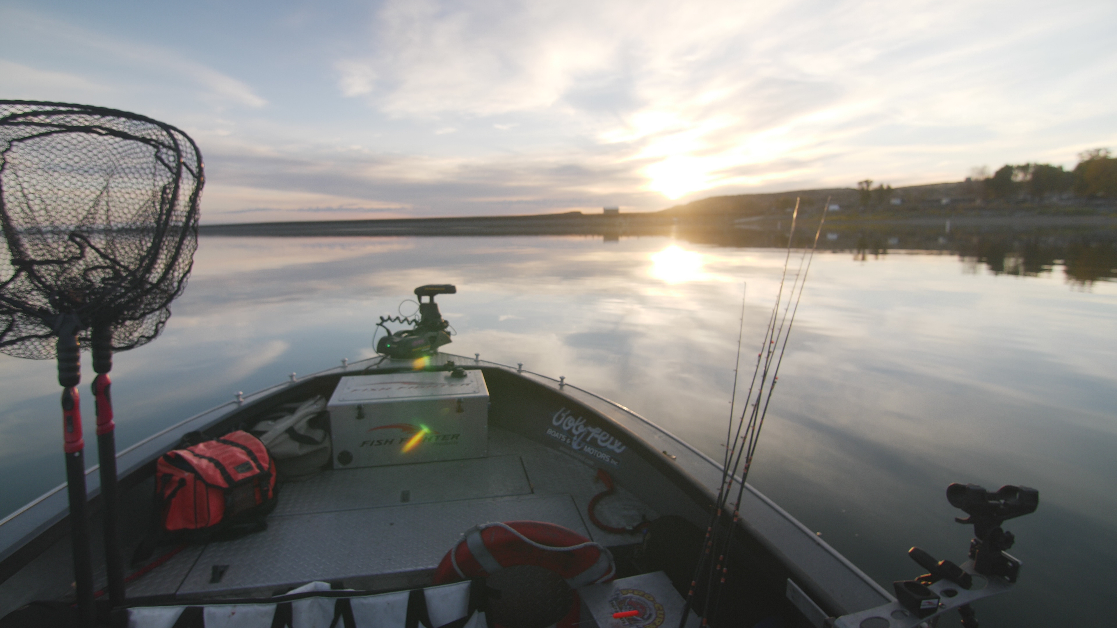View from boat and a man holding up his catch