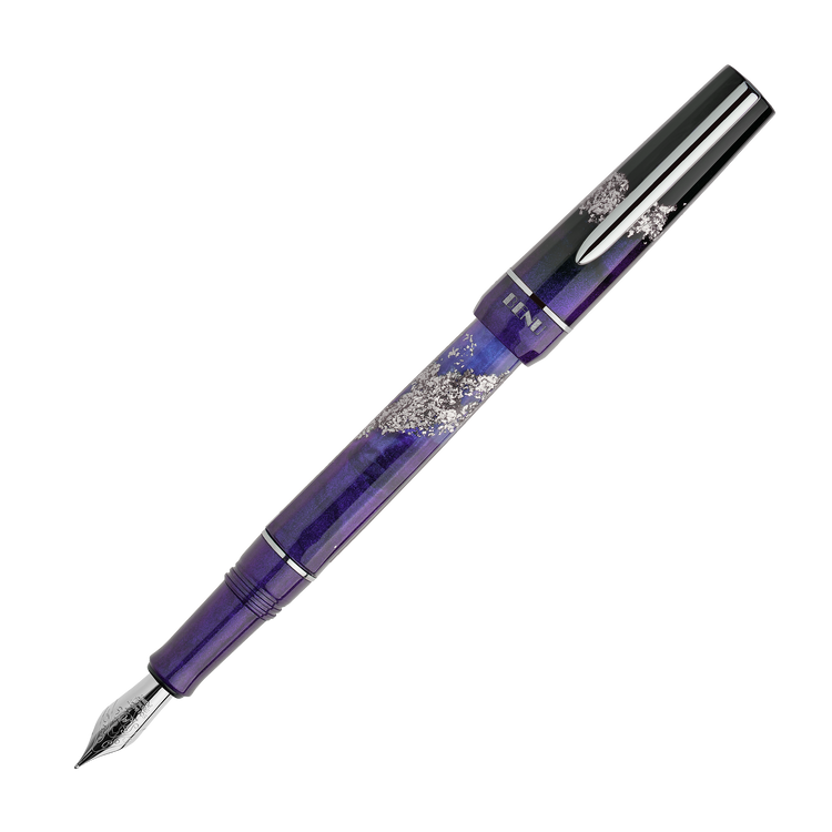 Icon Haute Fountain Pen - Benu. Benu Haute Icon fountain pen in deep purple-to-lilac shimmering resin with silver glitter, chrome trim, and multifaceted barrel, capped on white background.