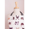 Felines peeping out of the apron