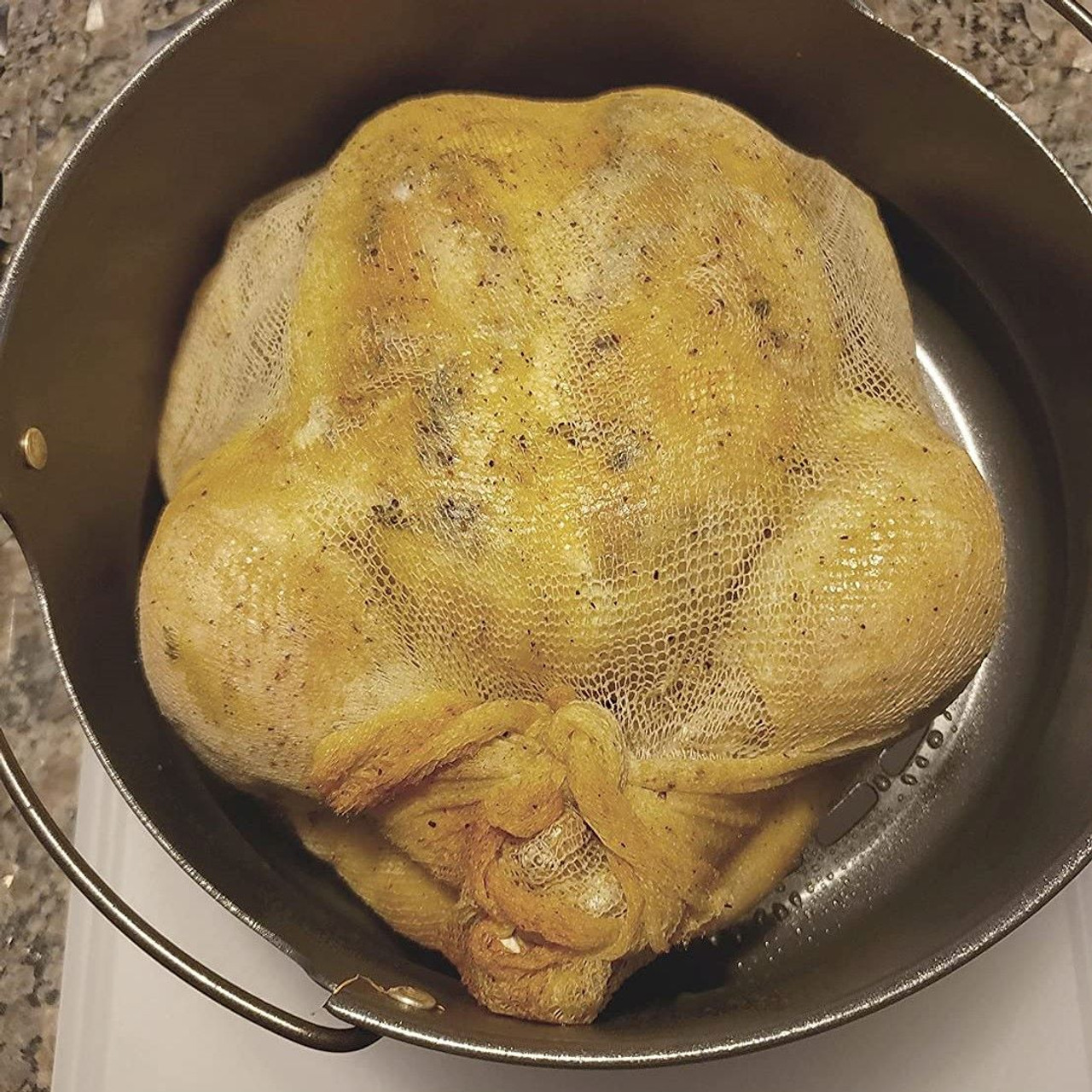 Pull a chicken from the stock to easily strain. 