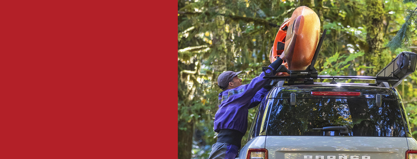 Paddler securing a kayak to a roof rack on top of a vehicleSummer Favorites