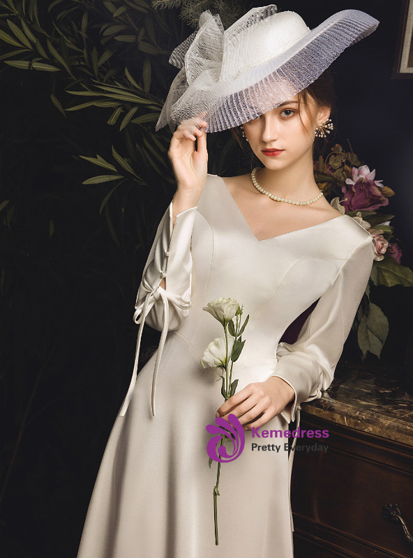 Ivory satin V neck long sleeve backless wedding dress with bow detail