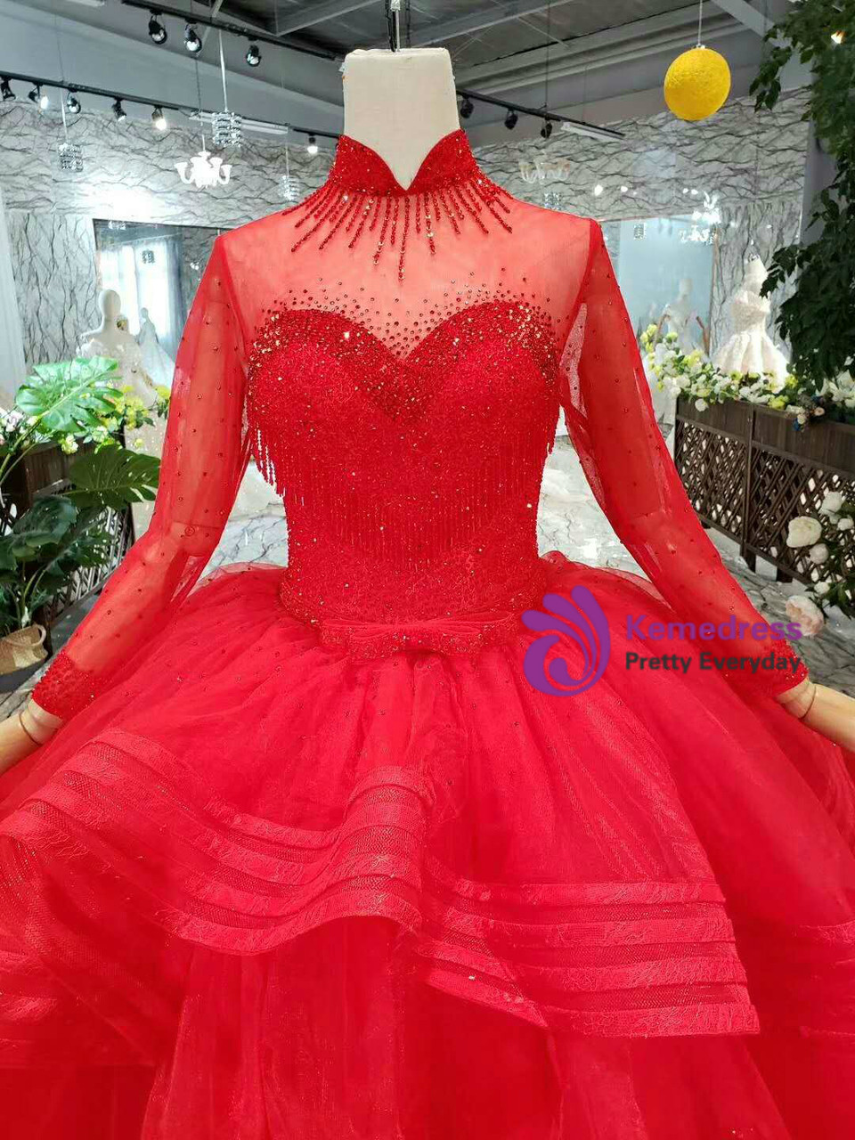 Red tulle princess wedding gown showing embellished bodice and flowing train