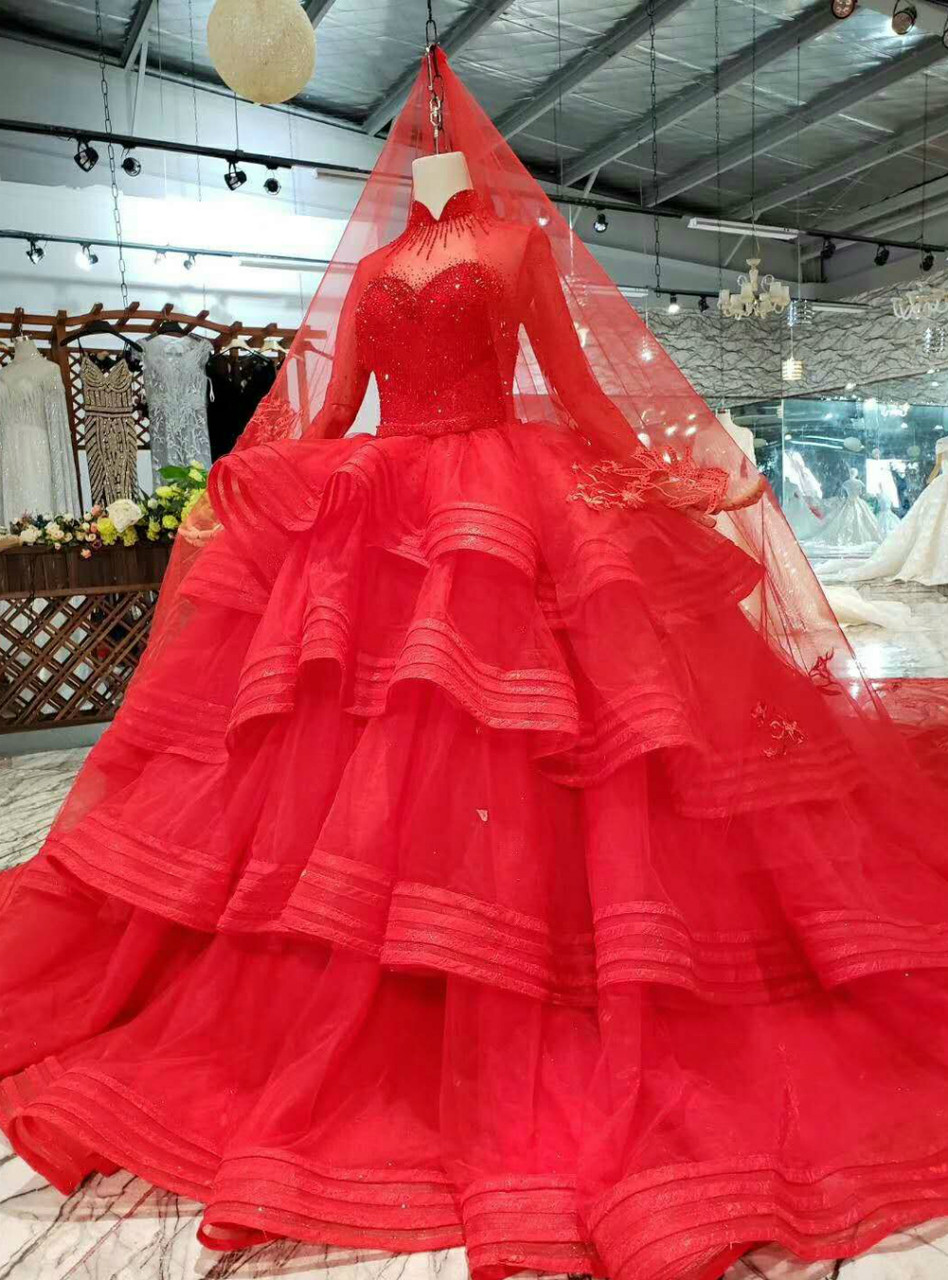 Red princess wedding dress with long sleeves and flowing tulle train